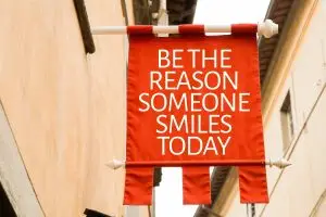 Photo of a banner encouraging people to be the reason someone smiles today