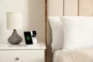 Photo of devices charging on a nightstand.