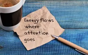 Photo of a note on a napkin saying "Energy flows where attention goes."