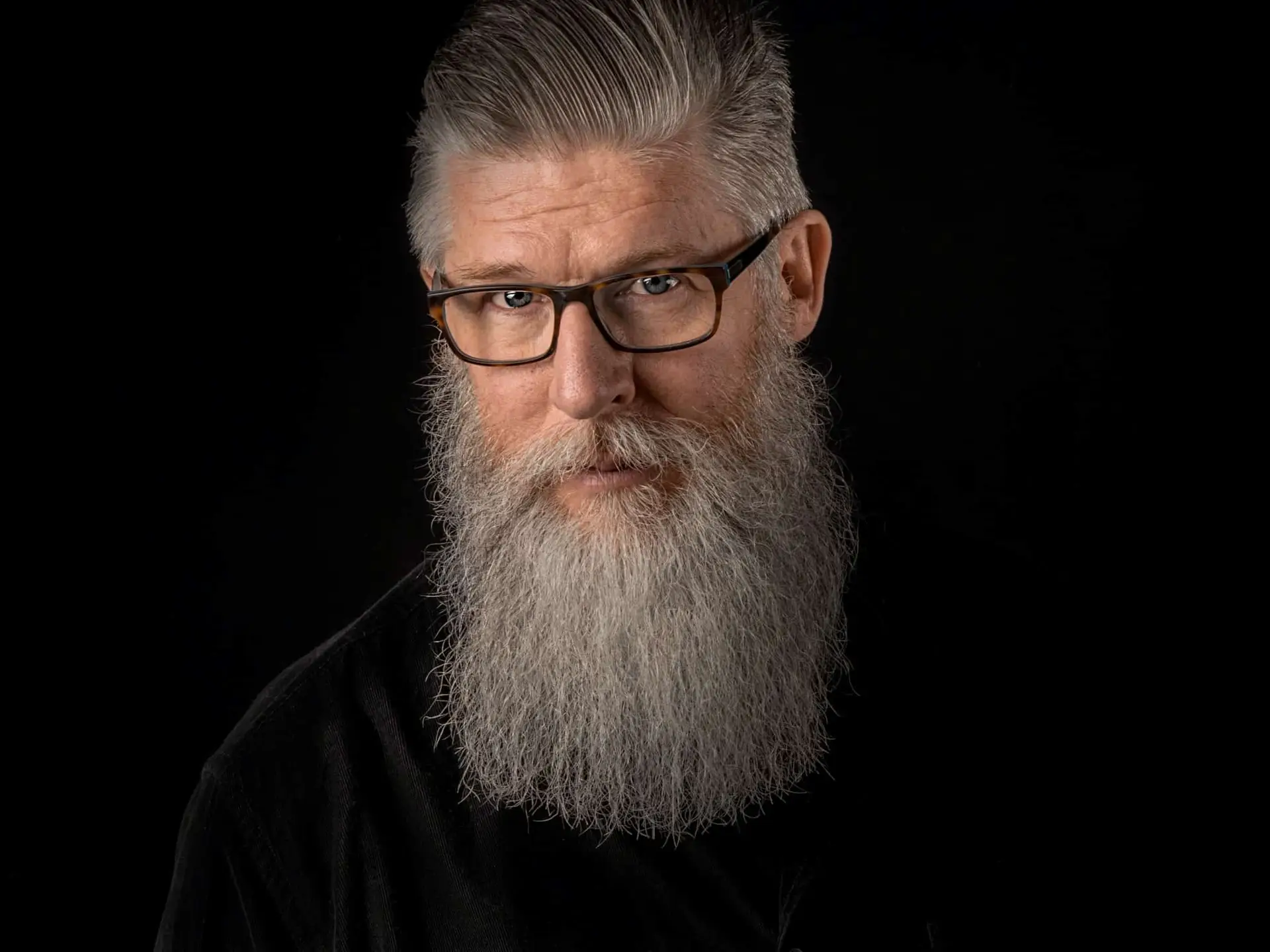 Photo of an older gray-haired man taken by JJ Jordan at Unsplash.