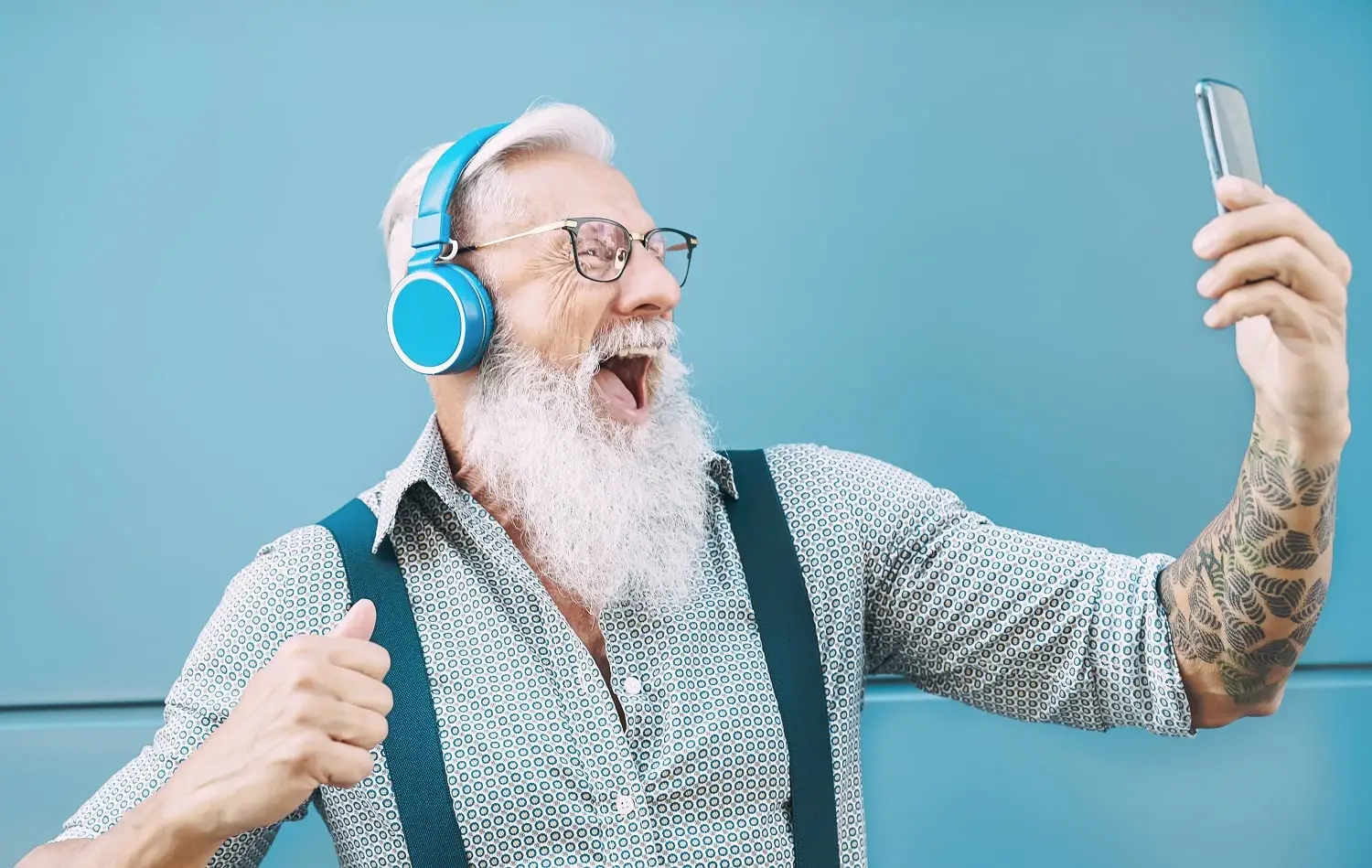 Photo of happy older man taking a selfie photograph.