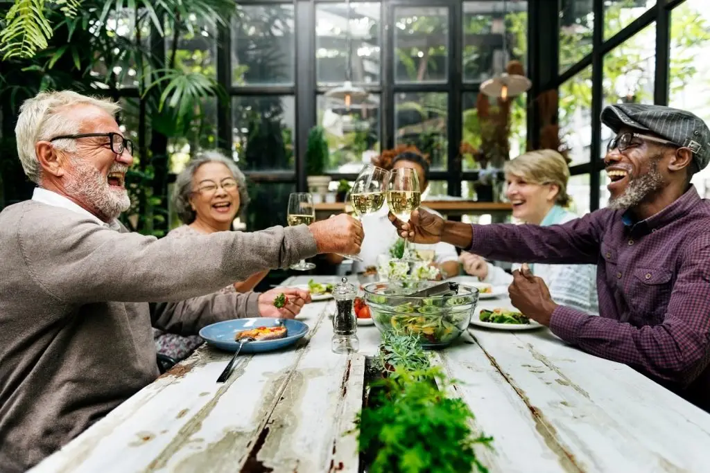 Photo of happy retirees enjoying dinner together.
