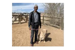 Photo of Kenny Cobbins with his dog, Cooper - Photo originally from Westword.