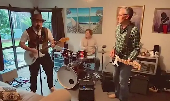 Photo of Ryan Stokes and his parents playing musical instruments