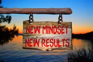 Photo of a sign with words "New mindset, new results."