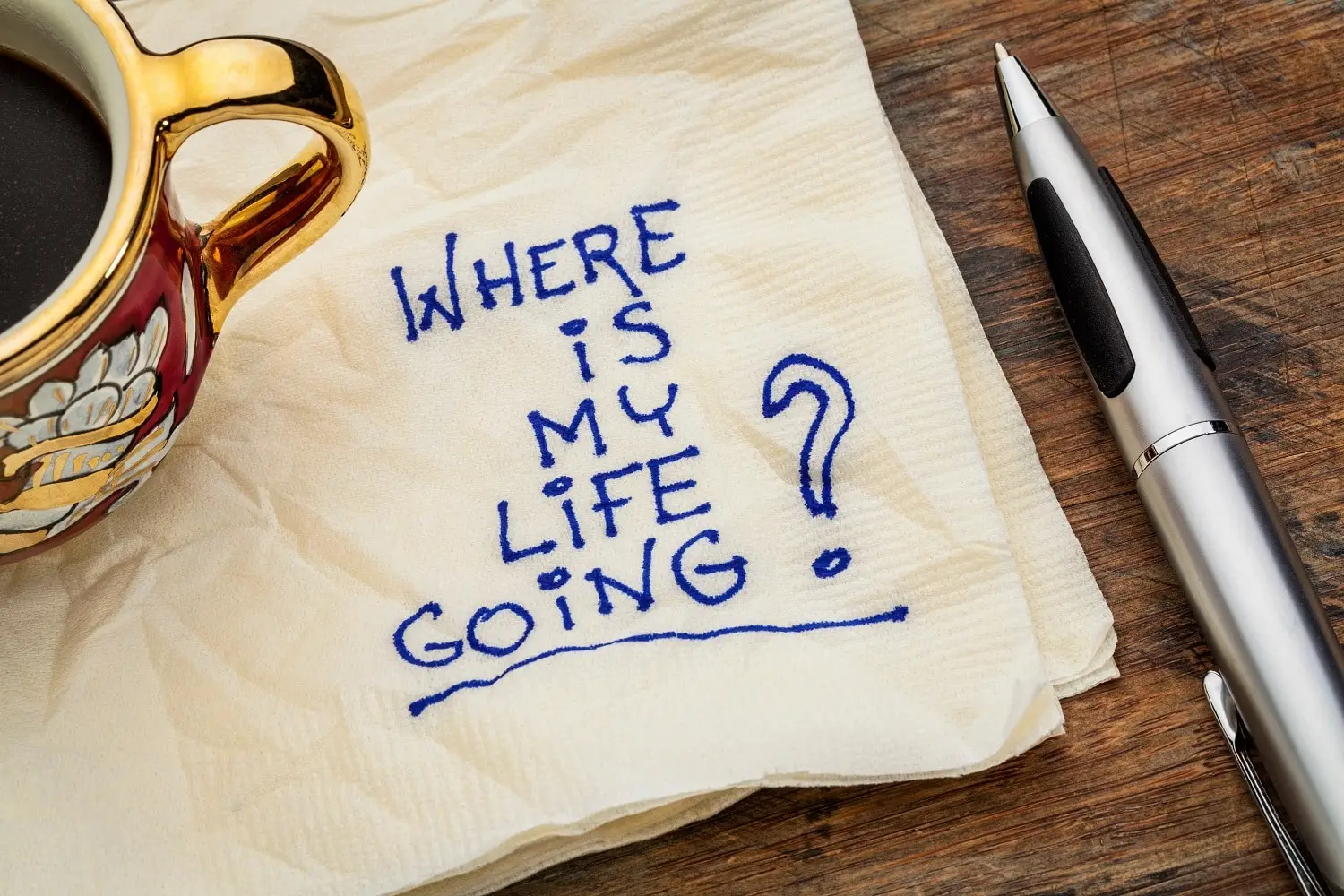 Photo of a napkin with a note written on it asking "Where is my life going?"