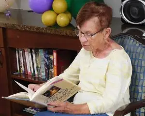 Photo of Irene Piersall reading to nursing home residents. Photo by Nancy Kennedy at the Citrus County Chronicle