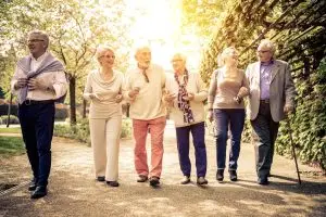 Photo of a group of older seasoned citizens walking outdoors