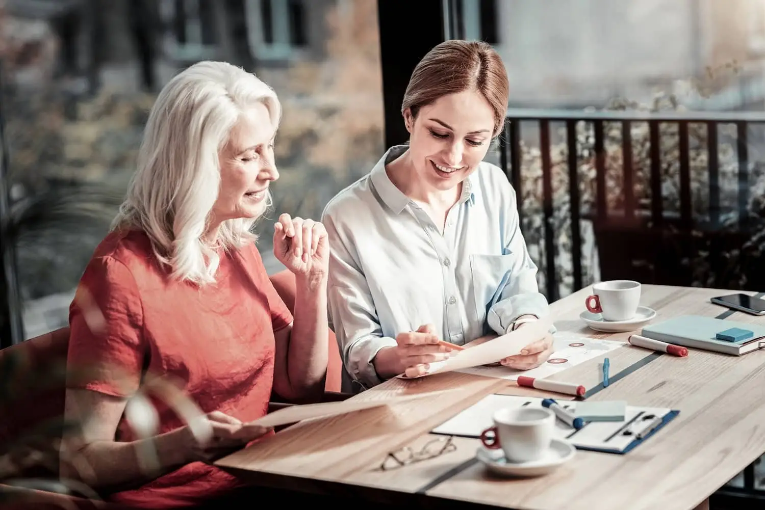 A baby boomer woman talks with a millennial woman.