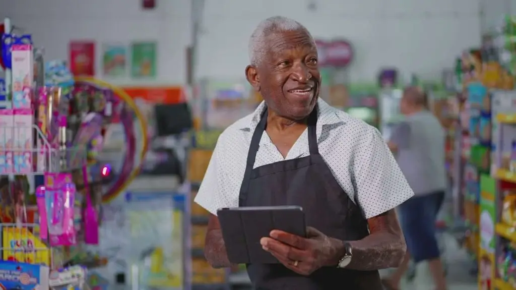 Photo of a happy, older worker engaged in purposeful job activity.