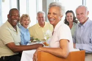 Photo of a group of happy seasoned citizens at a restaurant.