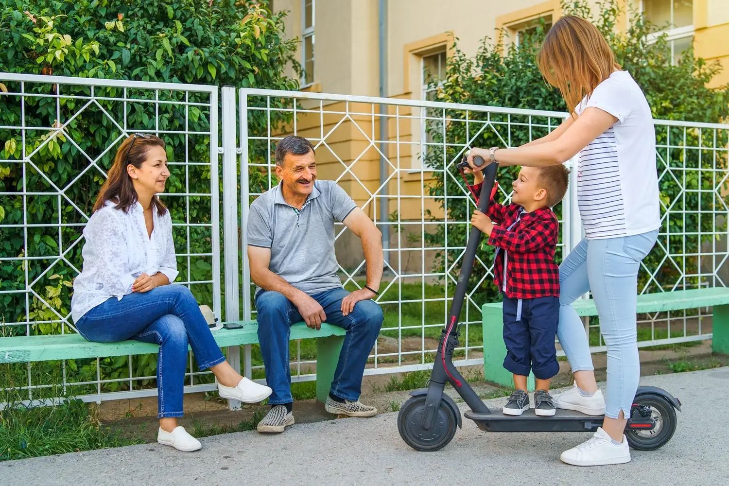 Photo of an intergenerational group outside of an apartment complex.