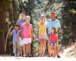Photo of a multi-generational family walking outdoors.