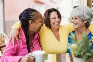 Photo of older women enjoying conversation and coffee.