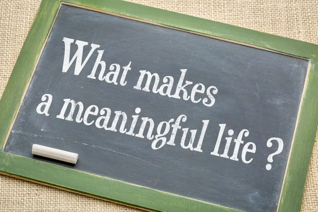 Chalkboard with message "What makes a meaningful life?"